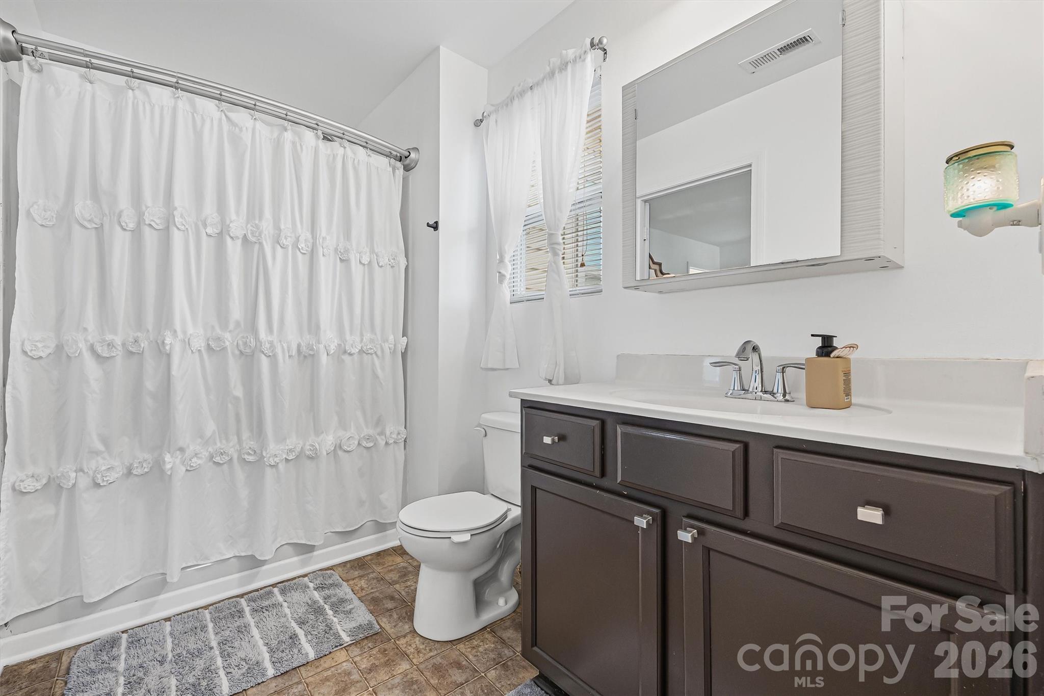831 Yale Street, Unit 30 Rock Hill, SC 29730 - Photo 20 of 30 a bathroom with a toilet a sink and mirror
