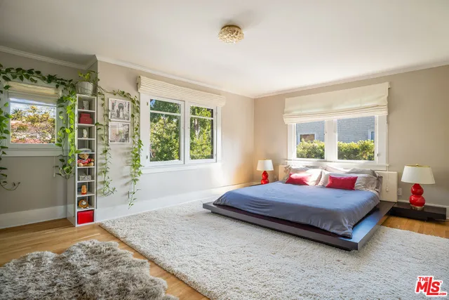 a bedroom with a bed and window