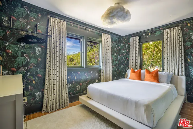 a bedroom with a large bed and a window