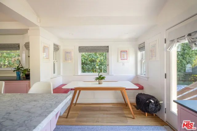 a room with pool table and glass windows
