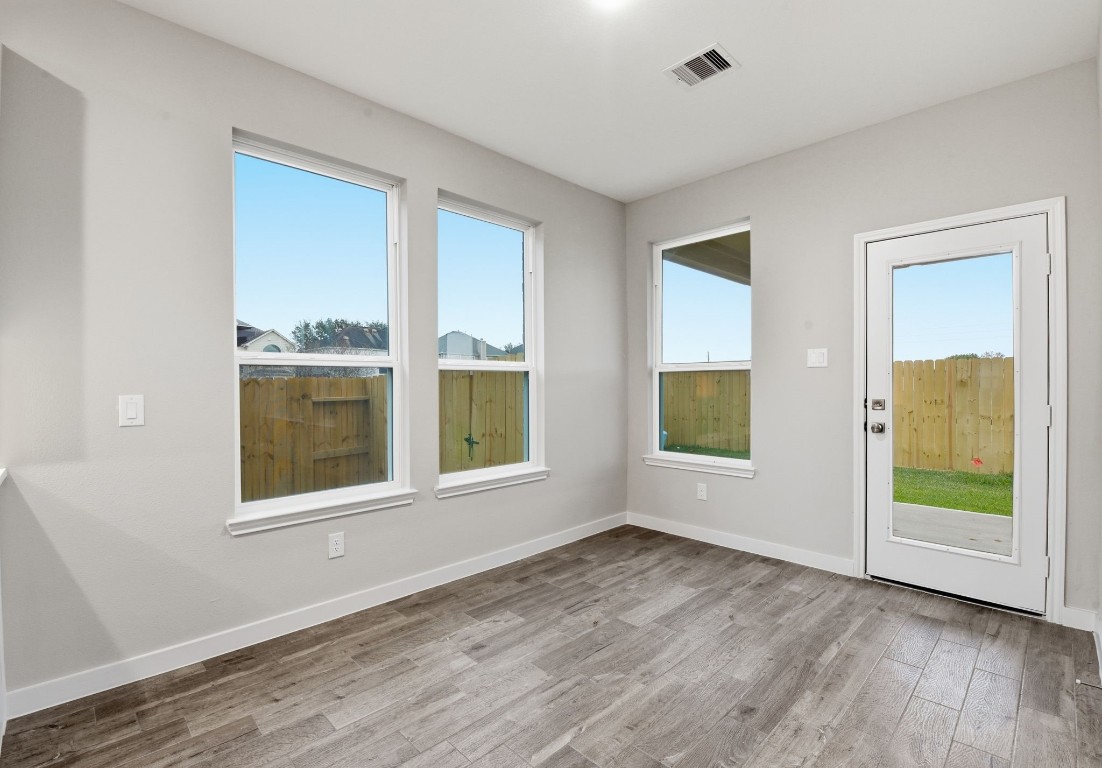 2415 Inlet Court Fresno, TX 77545 - Photo 13 of 50 a view of an empty room with a window and wooden floor