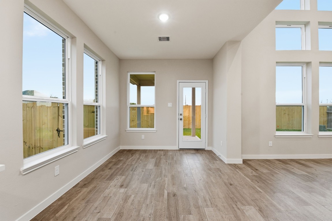 2415 Inlet Court Fresno, TX 77545 - Photo 15 of 50 wooden floor in an empty room with a window