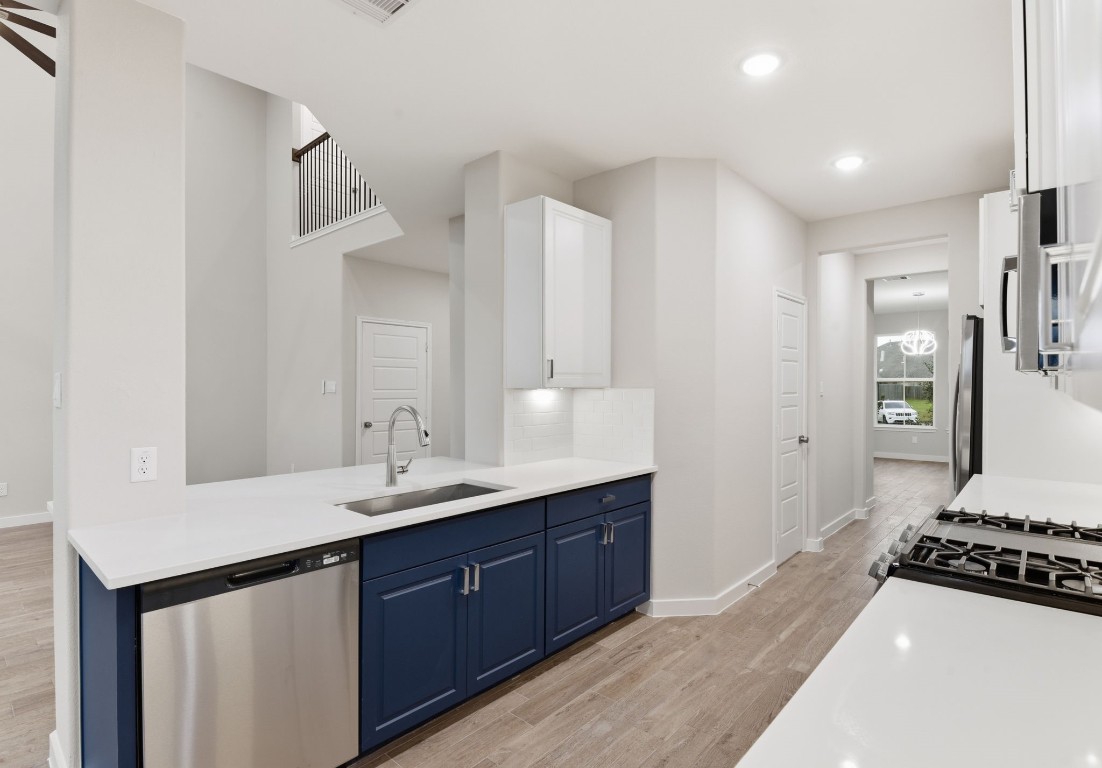 2415 Inlet Court Fresno, TX 77545 - Photo 18 of 50 a kitchen with a sink stove and refrigerator