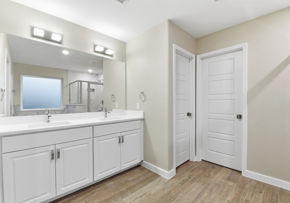 2415 Inlet Court Fresno, TX 77545 - Photo 32 of 50 a spacious bathroom with a double vanity sink a mirror and a shower