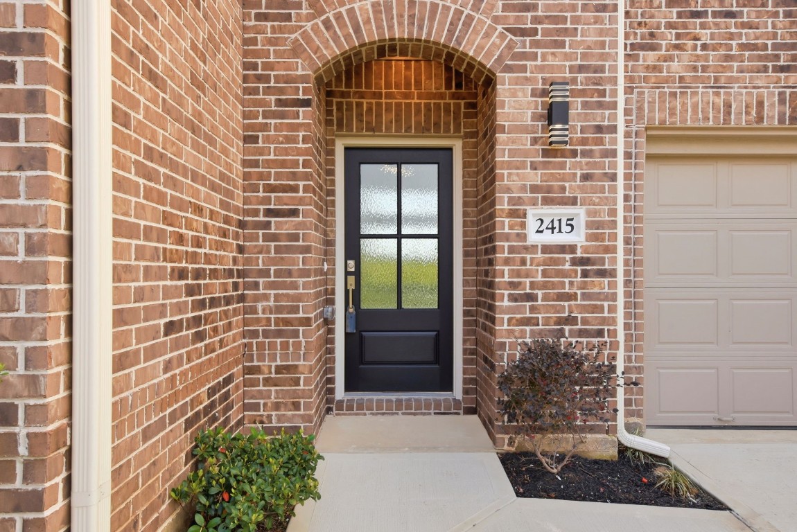 2415 Inlet Court Fresno, TX 77545 - Photo 4 of 50 a front view of a house with a garden