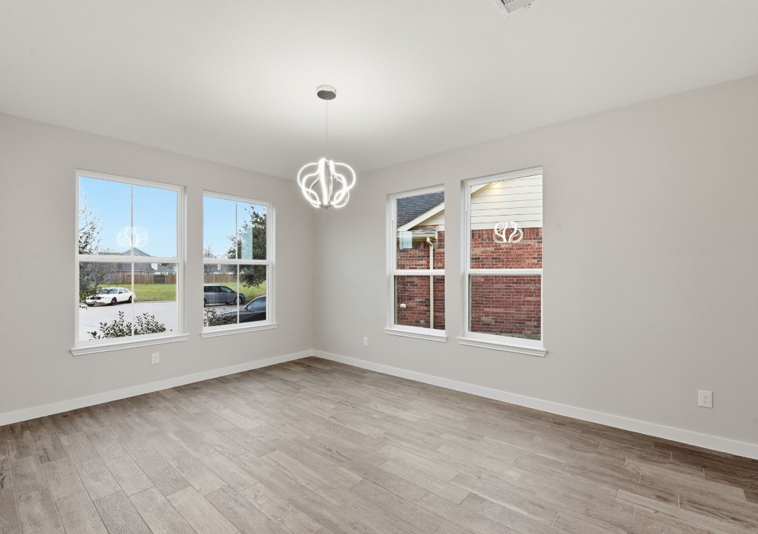 2415 Inlet Court Fresno, TX 77545 - Photo 7 of 50 an empty room with wooden floor and windows