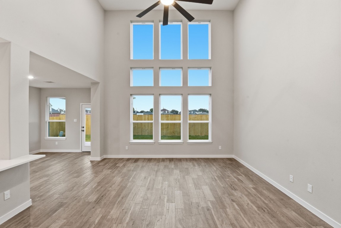 2415 Inlet Court Fresno, TX 77545 - Photo 9 of 50 an empty room with wooden floor and windows