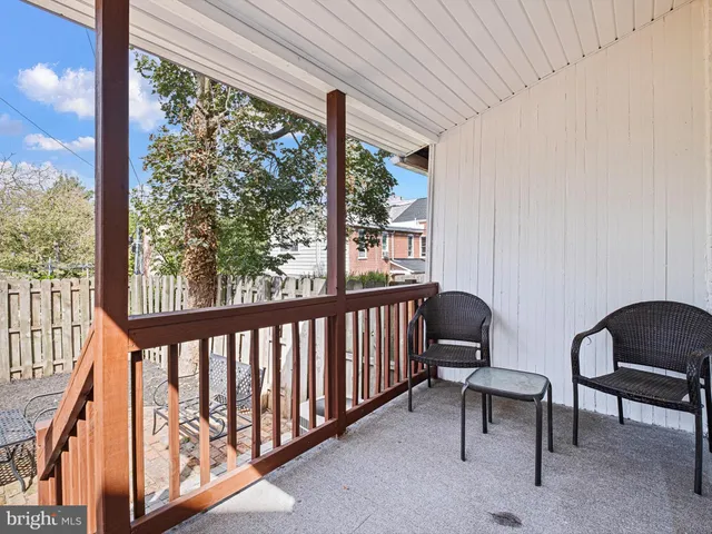 a view of a porch with furniture and a gate