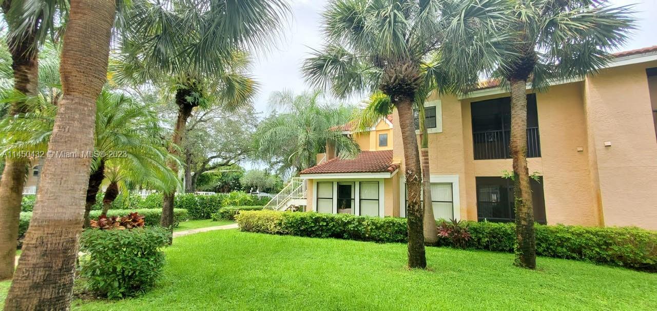 15661 Southwest 104th Terrace, Unit 321 Miami, FL 33196 - Photo 1 of 21 a front view of a house with yard and green space