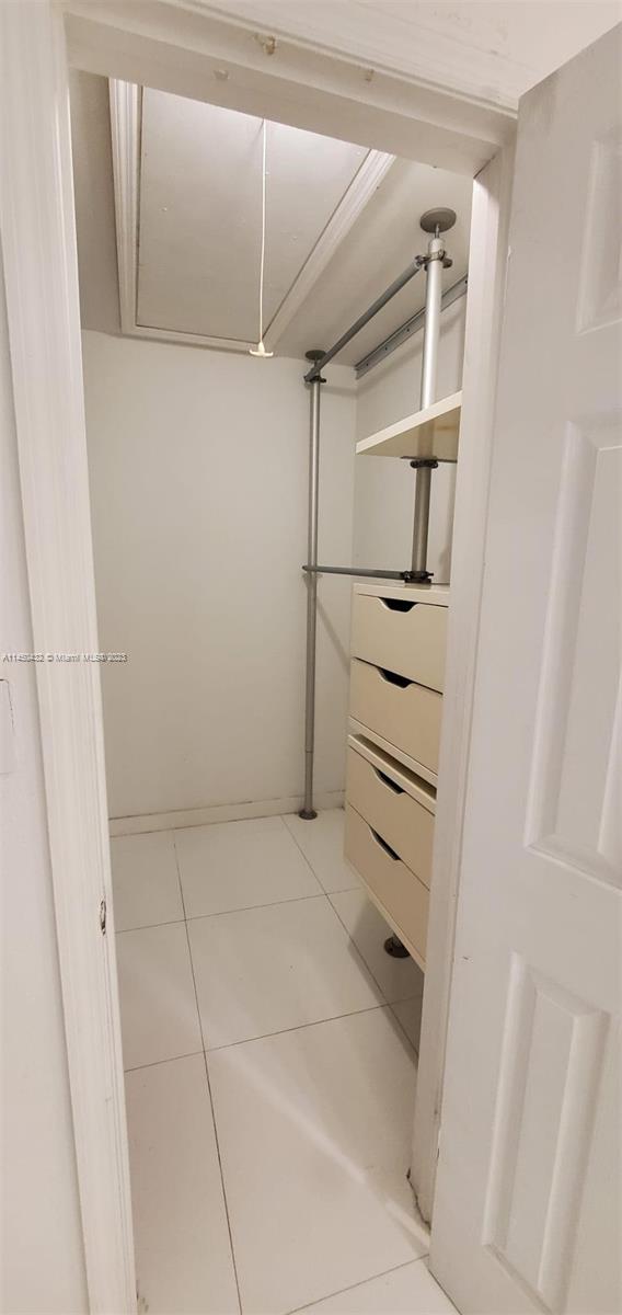 15661 Southwest 104th Terrace, Unit 321 Miami, FL 33196 - Photo 17 of 21 a view of walk in closet with empty racks
