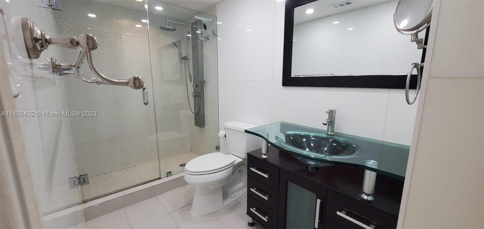 15661 Southwest 104th Terrace, Unit 321 Miami, FL 33196 - Photo 19 of 21 a bathroom with a sink a toilet and shower