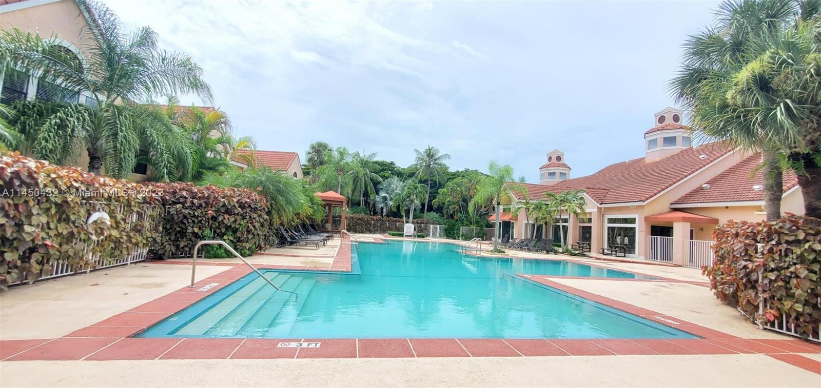 15661 Southwest 104th Terrace, Unit 321 Miami, FL 33196 - Photo 20 of 21 a view of a swimming pool with a patio