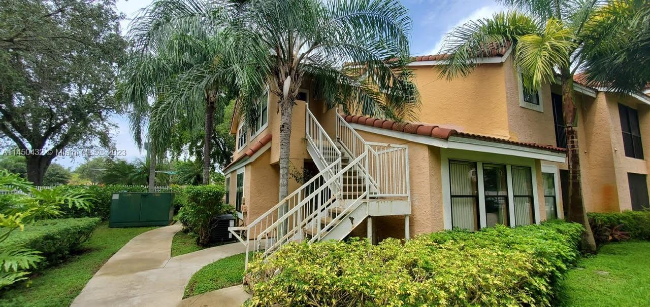 15661 Southwest 104th Terrace, Unit 321 Miami, FL 33196 - Photo 2 of 21 front view of a house with a yard