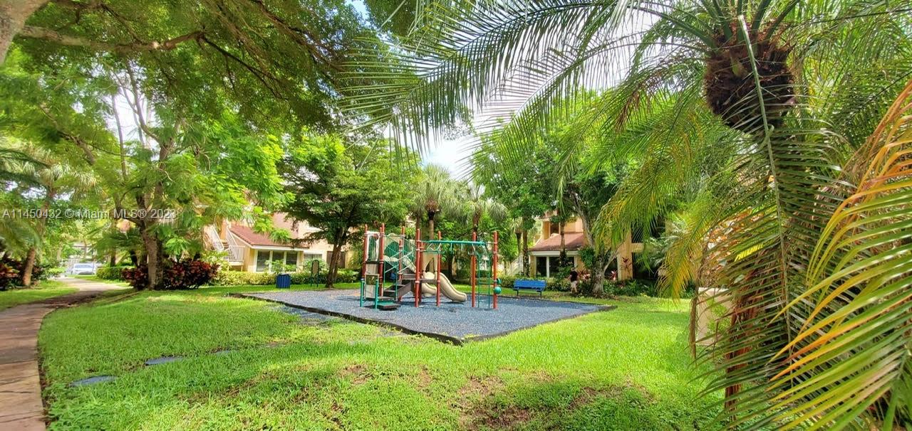 15661 Southwest 104th Terrace, Unit 321 Miami, FL 33196 - Photo 21 of 21 a swimming pool with outdoor seating and yard