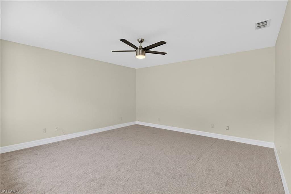 5012 Fairhaven Lane Naples, FL 34109 - Photo 24 of 28 an empty room with a window and a ceiling fan