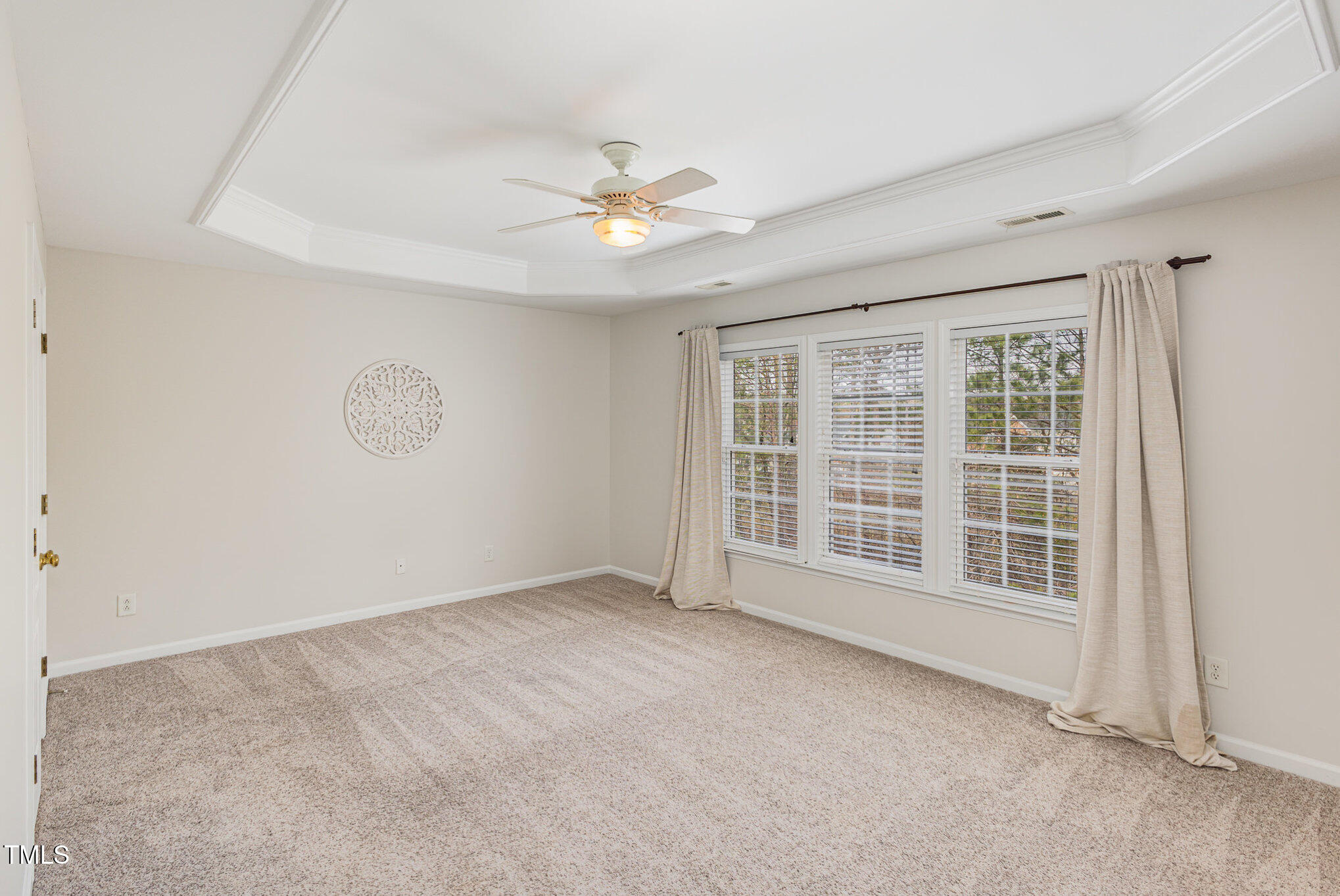 7533 Silver View Lane Raleigh, NC 27613 - Photo 12 of 25 an empty room with chandelier fan and windows
