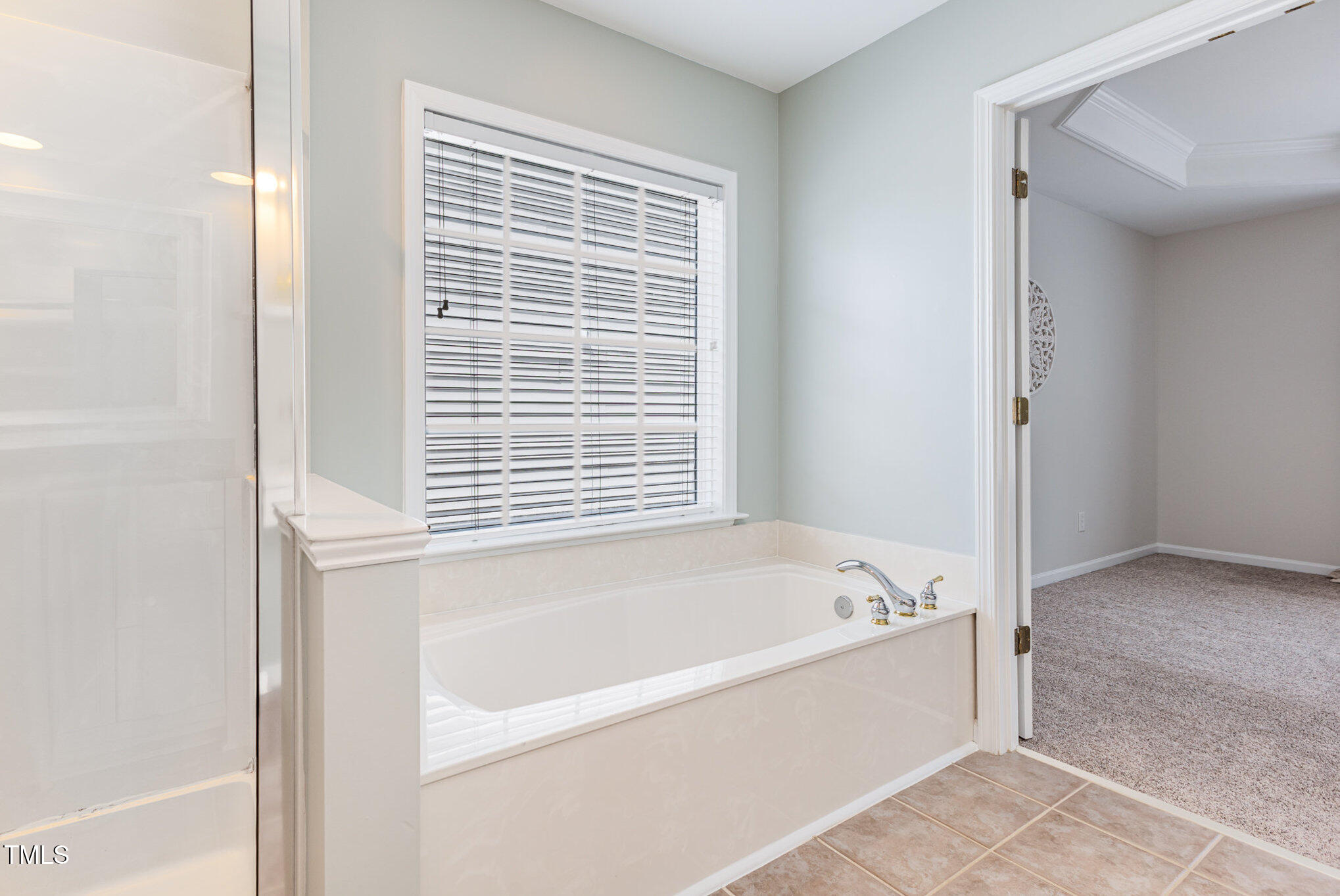 7533 Silver View Lane Raleigh, NC 27613 - Photo 15 of 25 a white bath tub sitting next to a window