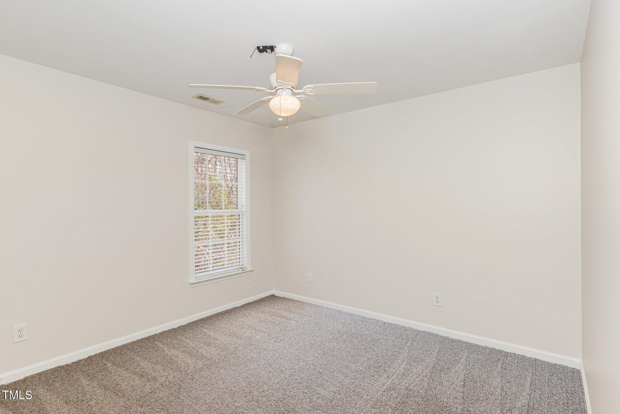 7533 Silver View Lane Raleigh, NC 27613 - Photo 18 of 25 an empty room with windows and fan