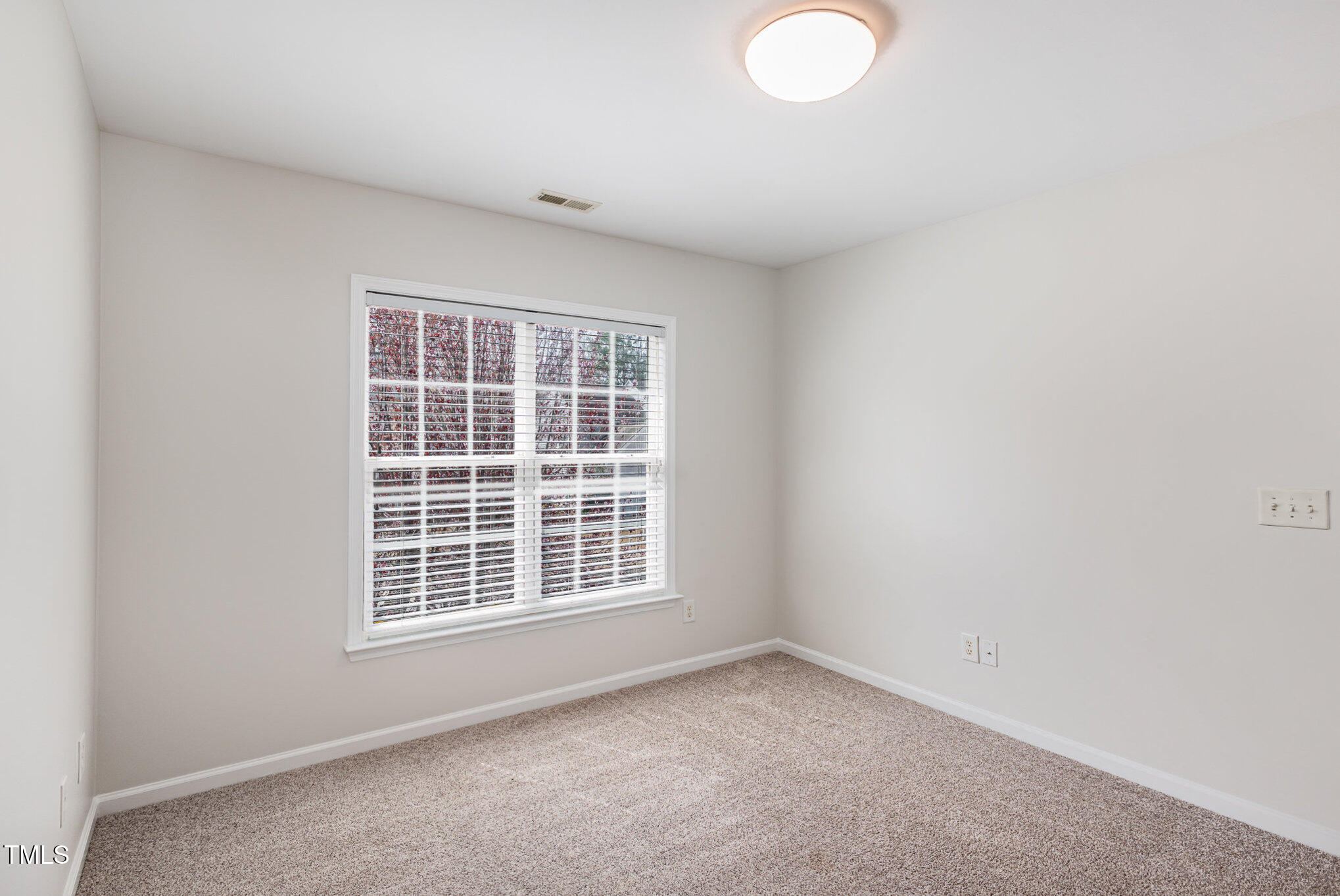 7533 Silver View Lane Raleigh, NC 27613 - Photo 21 of 25 an empty room with a window