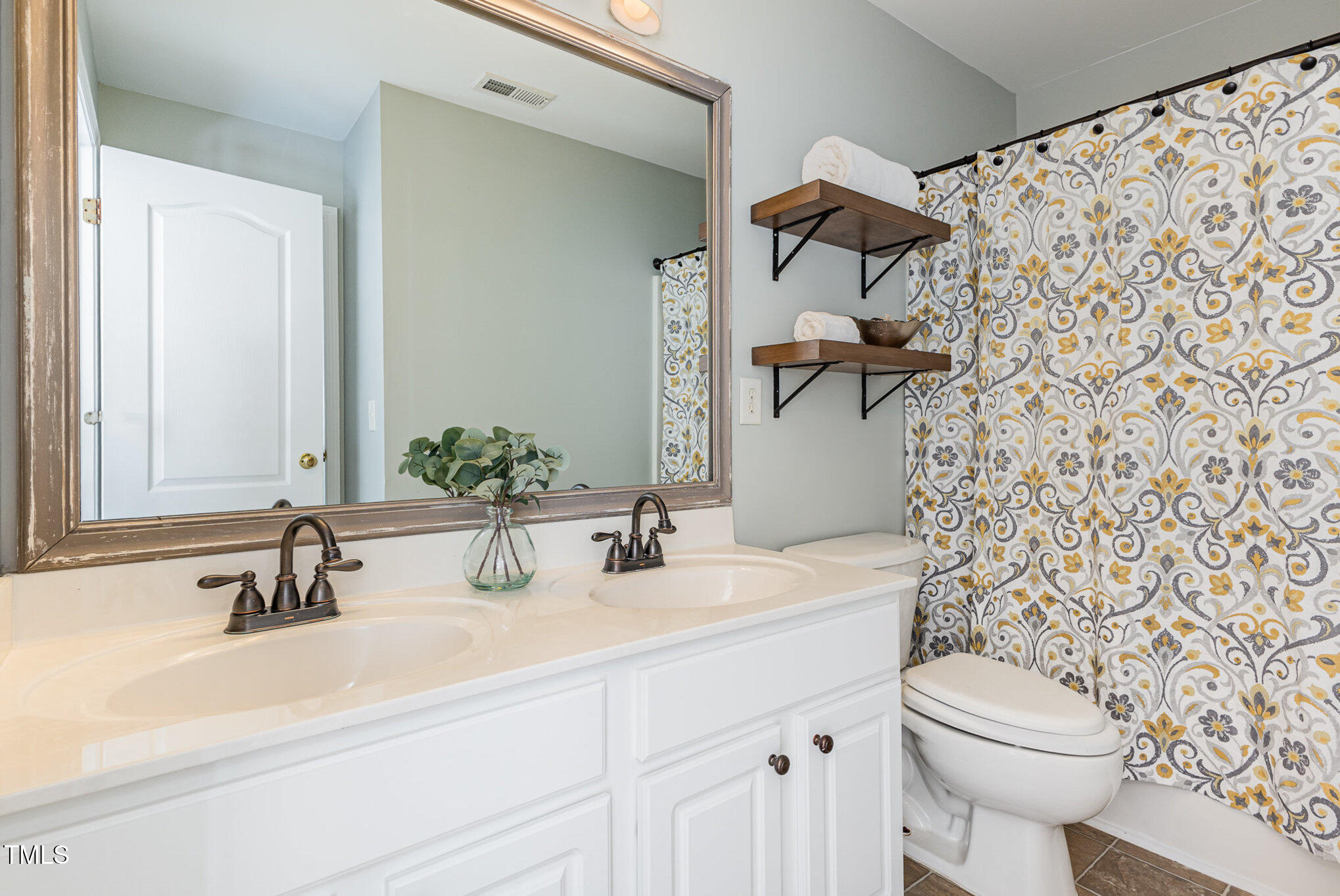 7533 Silver View Lane Raleigh, NC 27613 - Photo 23 of 25 a bathroom with a sink and a mirror