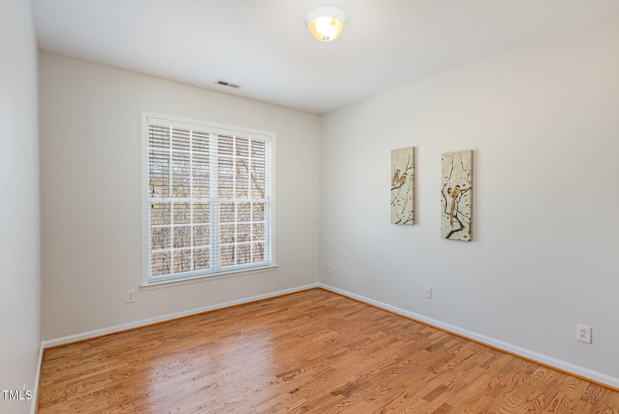 7533 Silver View Lane Raleigh, NC 27613 - Photo 4 of 25 an empty room with a window