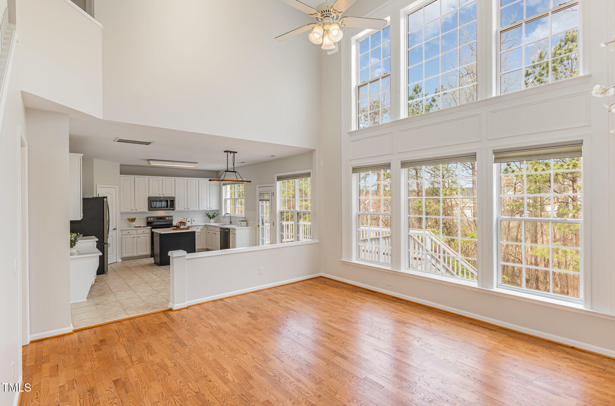 7533 Silver View Lane Raleigh, NC 27613 - Photo 5 of 25 a view of an empty room with kitchen and a window