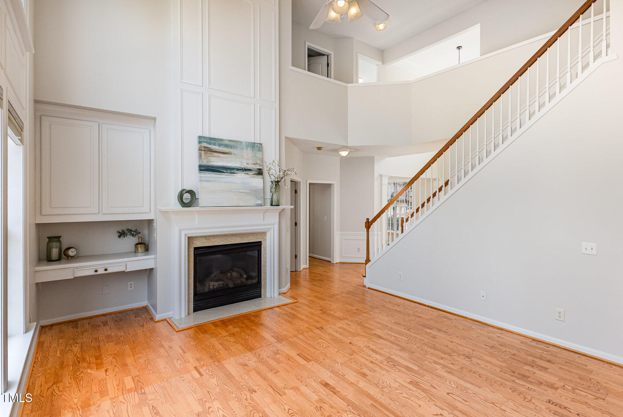 7533 Silver View Lane Raleigh, NC 27613 - Photo 6 of 25 a view of a kitchen and an empty room with wooden floor