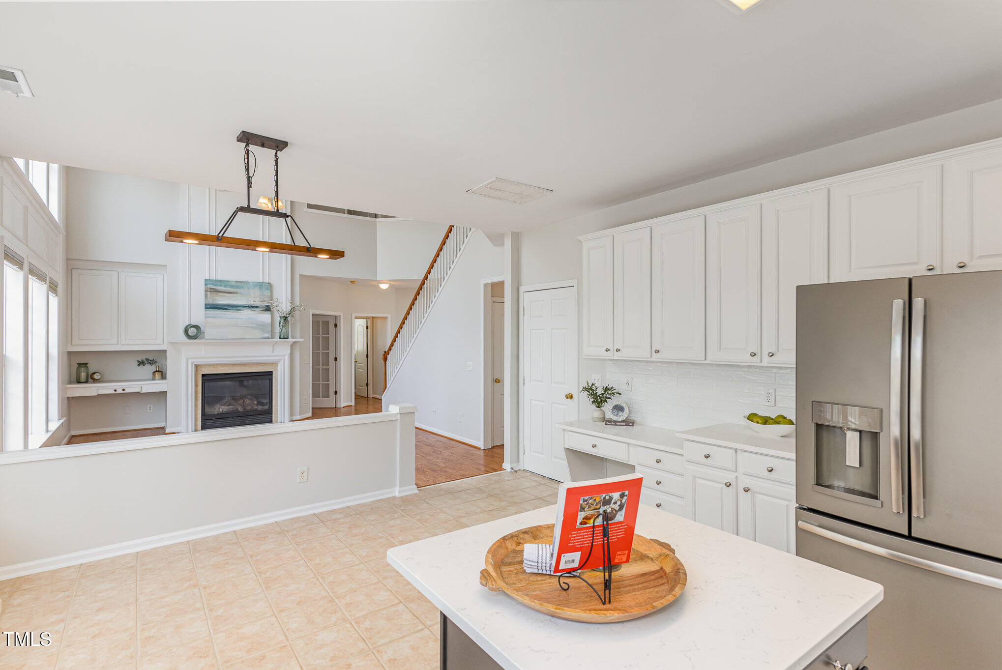 7533 Silver View Lane Raleigh, NC 27613 - Photo 9 of 25 a living room with stainless steel appliances furniture a rug and a kitchen view
