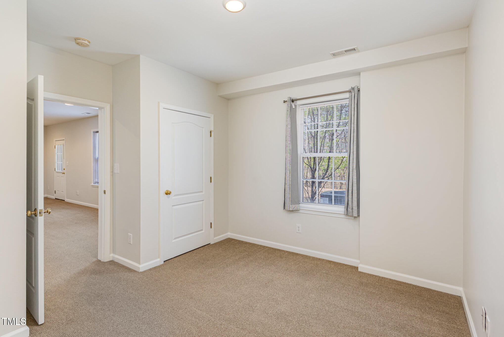 7533 Silver View Lane Raleigh, NC 27613 - Photo 10 of 25 an empty room with a window and a bathroom