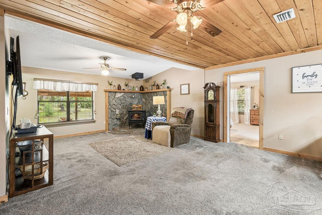 8938 Pioneer Road Holt, FL 32564 - Photo 6 of 44 a spacious bedroom with a large bed and a chandelier