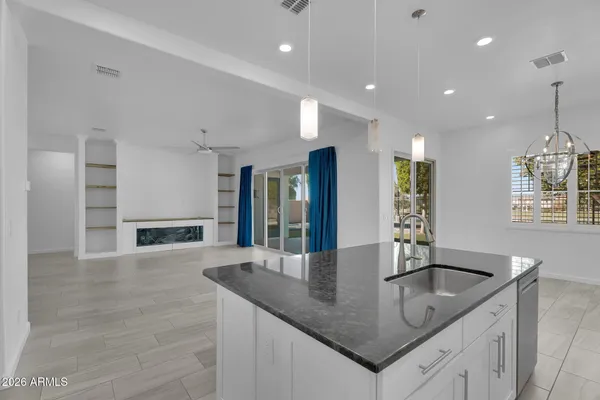 a kitchen with granite countertop a stove and a sink