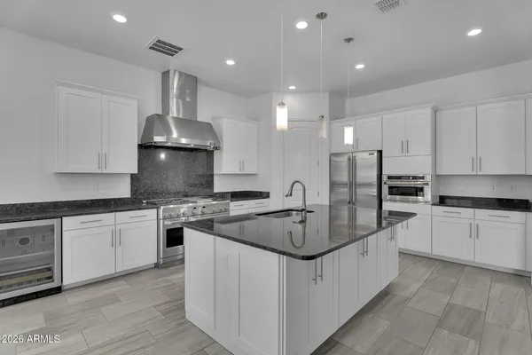 a view of an empty room with ceiling fan and window