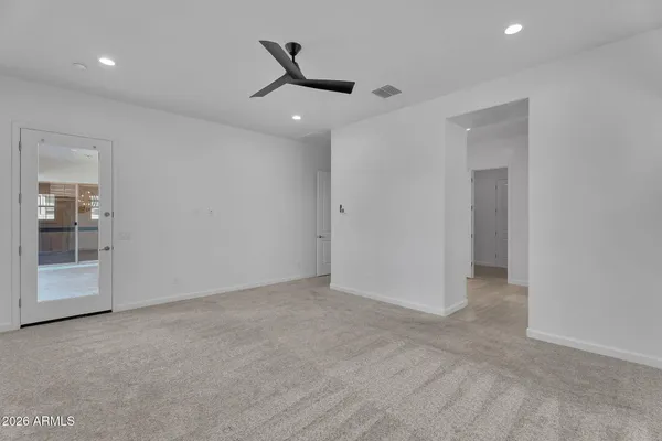 an empty room with a empty space and a ceiling fan