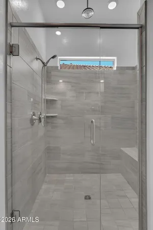 a bathroom with a sink double vanity granite tub and a mirror