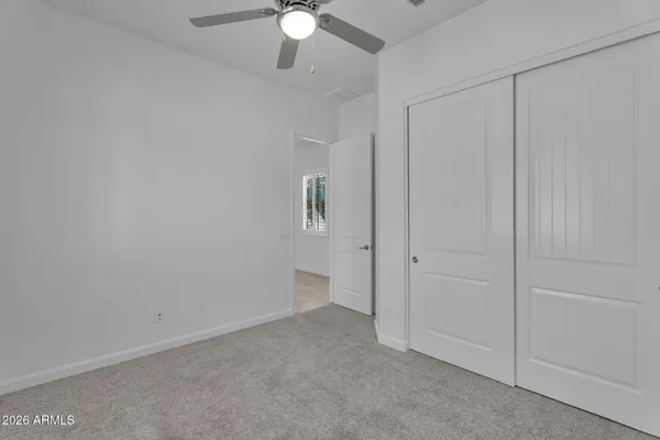 a view of a backyard with swimming pool and sitting area