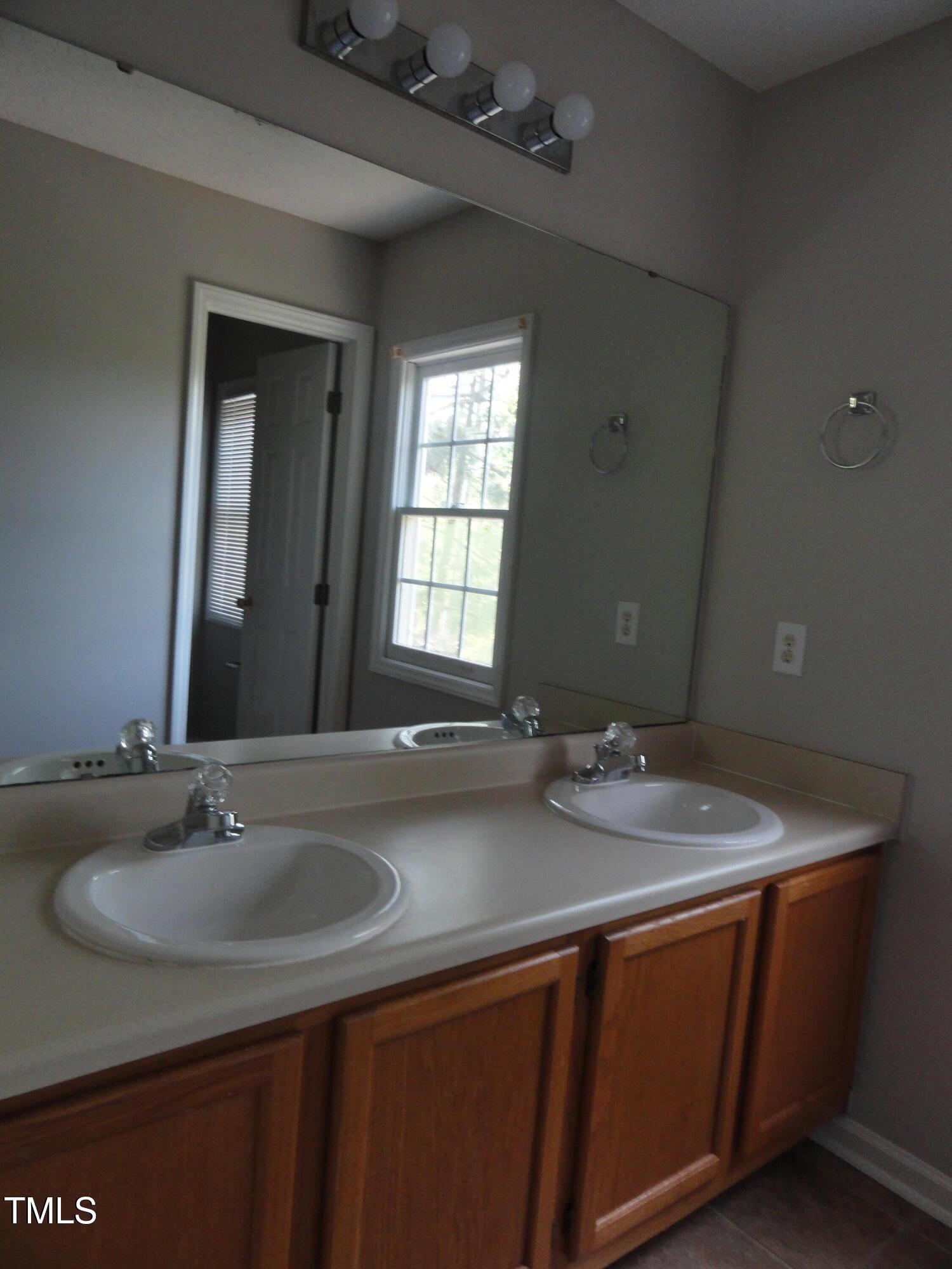 201 Union Mills Way Cary, NC 27519 - Photo 12 of 15 a bathroom with a granite countertop sink and a mirror