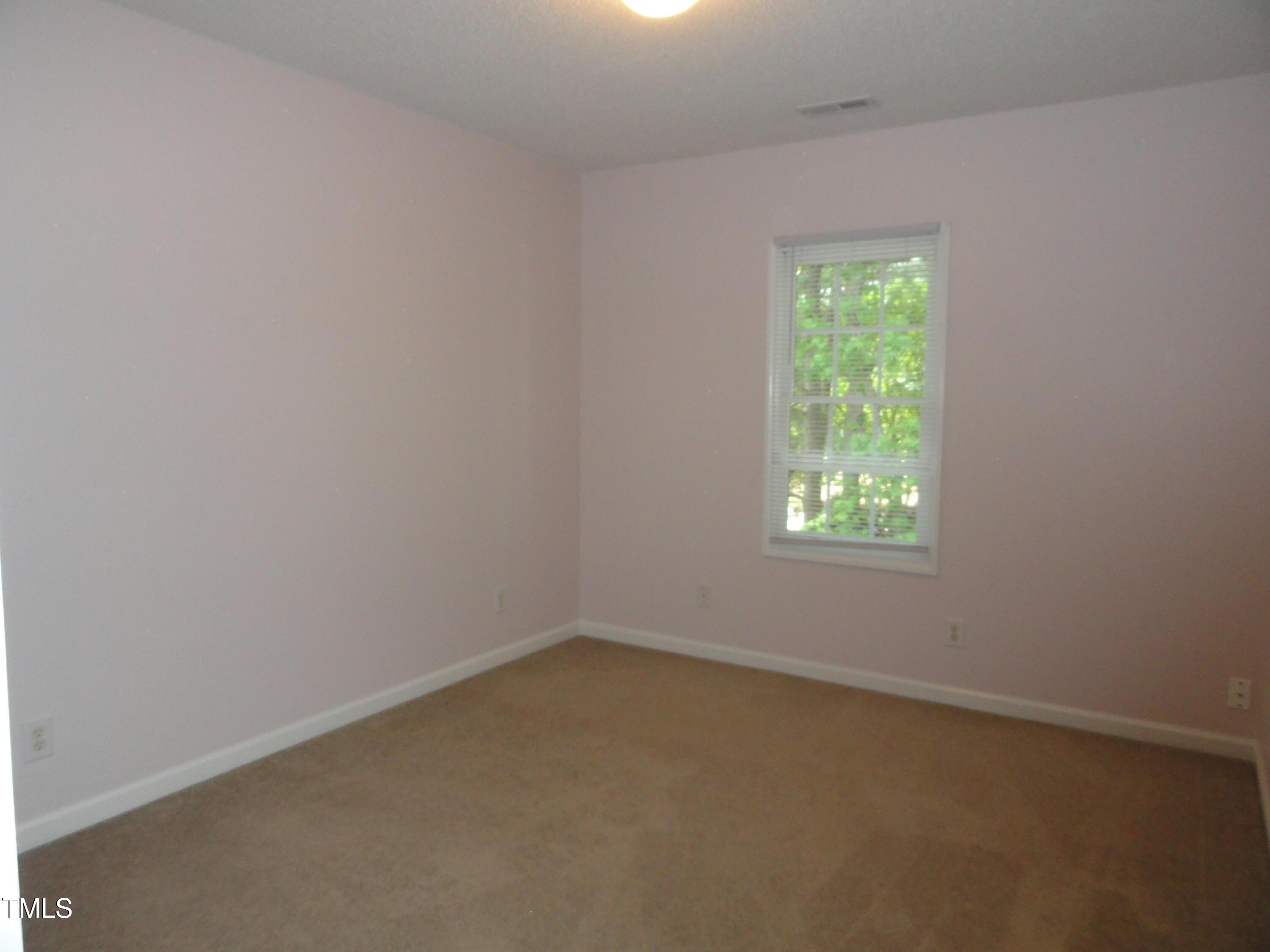 201 Union Mills Way Cary, NC 27519 - Photo 8 of 15 an empty room with a window