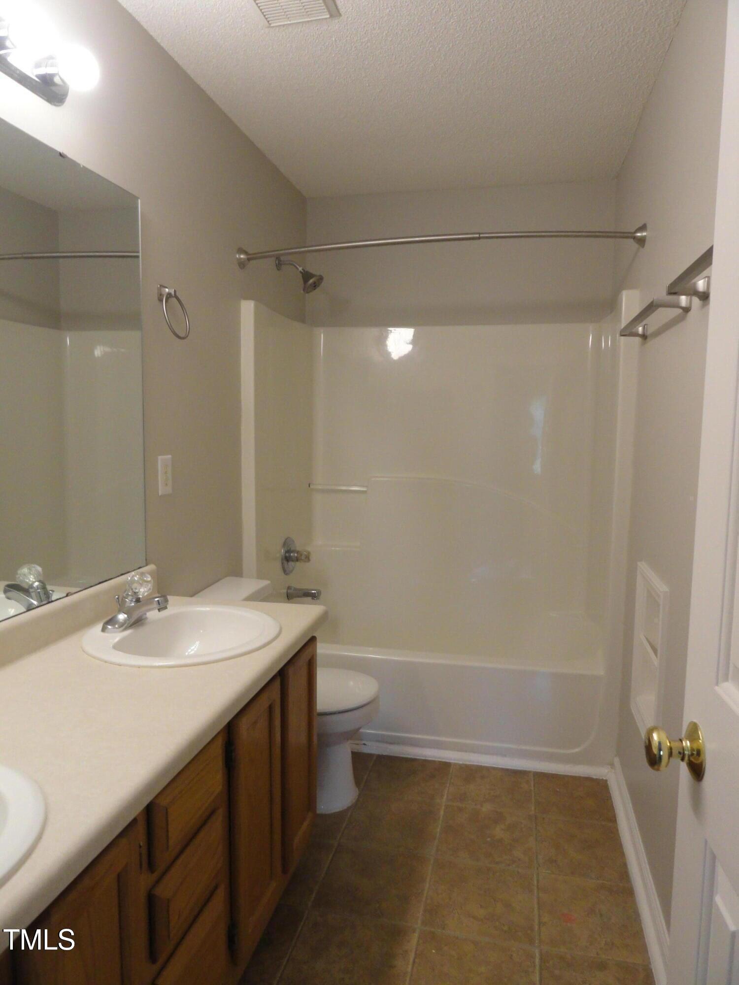 201 Union Mills Way Cary, NC 27519 - Photo 10 of 15 a bathroom with a sink a toilet and shower