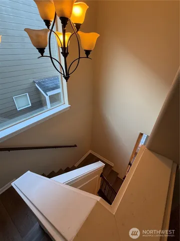 a bathroom with a granite countertop sink a toilet a mirror and vanity