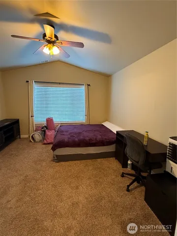 a bathroom with a granite countertop toilet sink and mirror