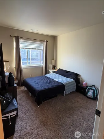 a room with furniture a rug and a window