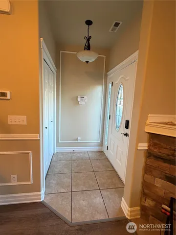 wooden floor in an empty room with a mirror