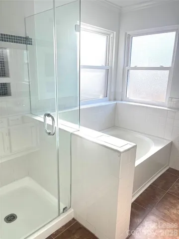 a bathroom with a tub and a shower