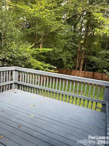 a view of a wooden deck and trees