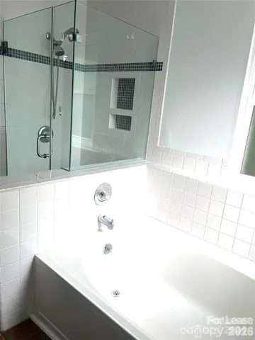 a bathroom with a bathtub and a shower