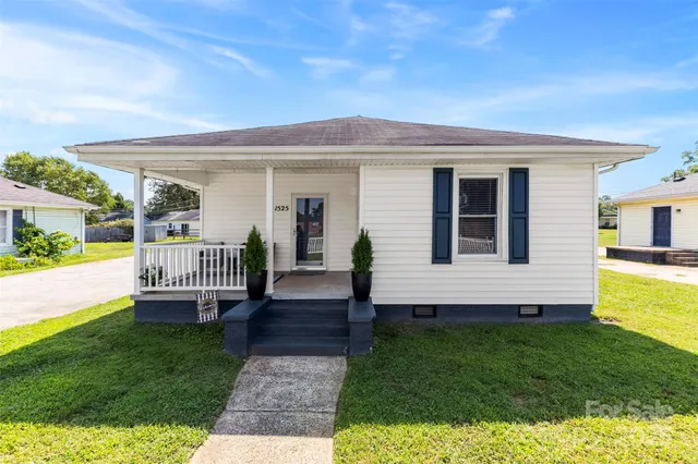 a view of a house with a backyard and a patio
