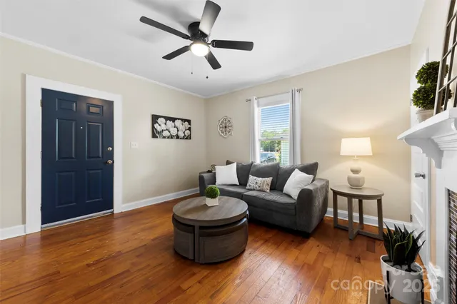 a living room with furniture and a wooden floor