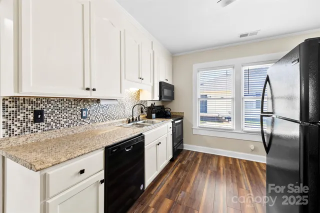 a kitchen with a sink stove and refrigerator