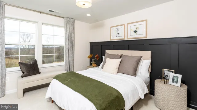 a bedroom with bed and a couch