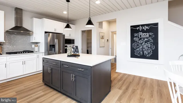 a kitchen with stainless steel appliances granite countertop a sink and a stove